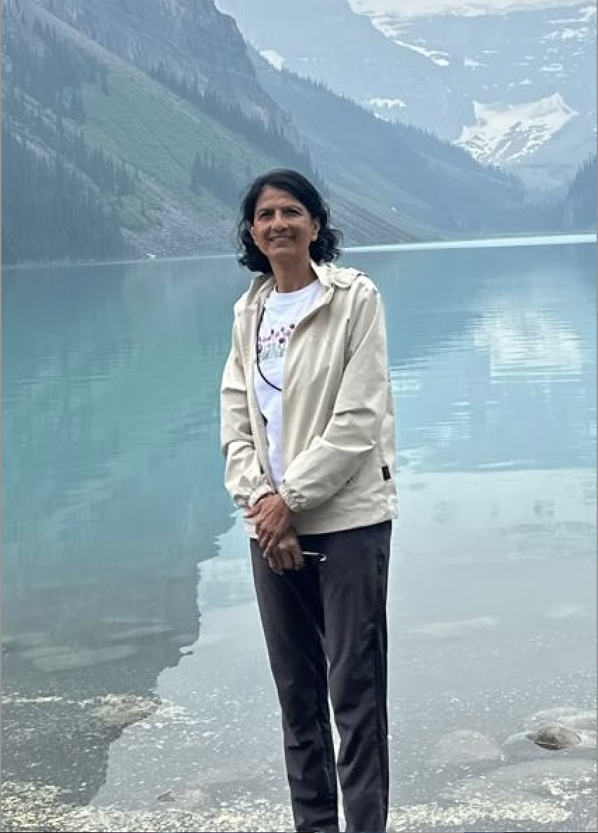 Dr. Vinaya Bhagwat beside a mountain lake